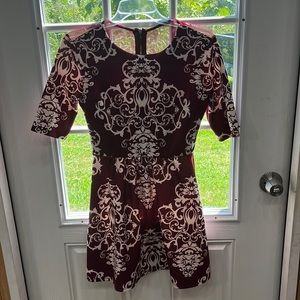 Like New size 7/8 wine-red B Darlin dress with an abstract design with mesh back
